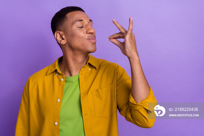 Photo portrait of handsome young man try tasty food gourmet gesture wear trendy yellow garment isolated on purple color background