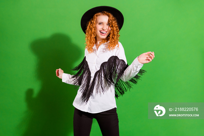 Portrait of attractive carefree cheerful wavy-haired girl dancing having fun resting isolated over bright green color background