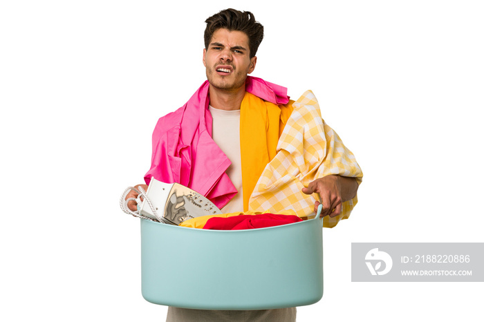 Young caucasian man doing laundry isolated on white background