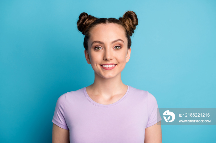 Closeup photo of attractive teen lady two funny buns good mood toothy white smile charming cute appearance nice person youngster wear casual purple t-shirt isolated blue color background