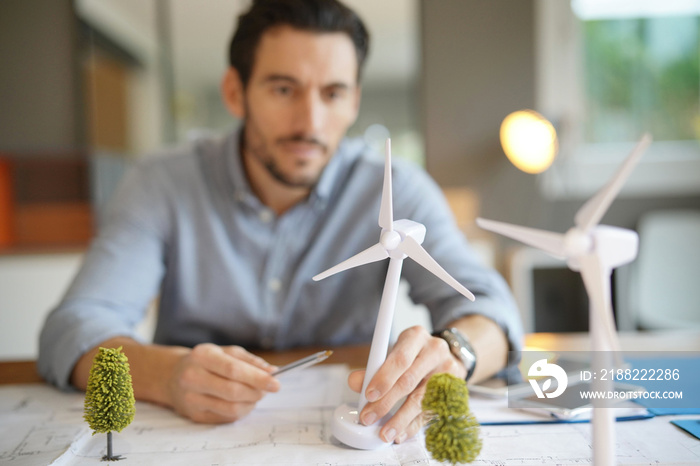 Handsome wind turbine engineer working in modern office