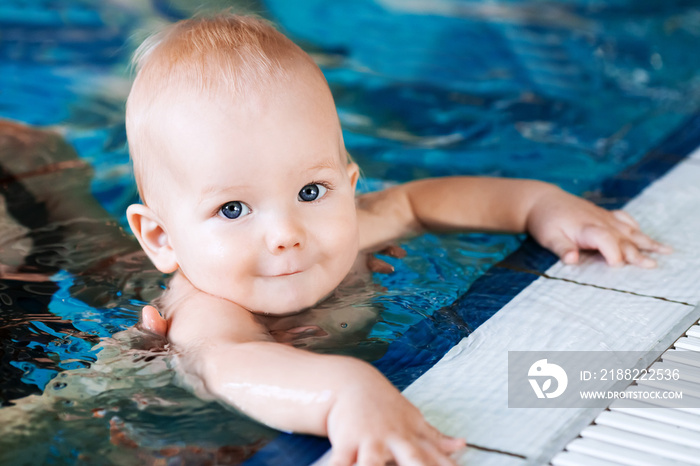 Smiling charming baby in swimming pool