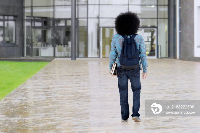 Afro student walks at school yard