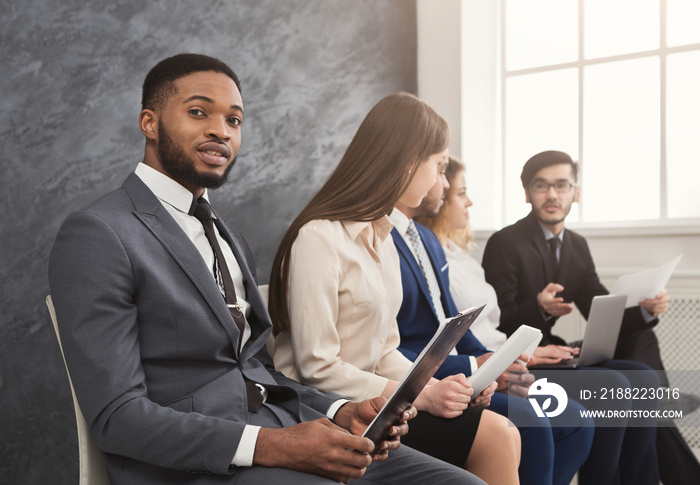 Multiracial people waiting in queue preparing for job interview