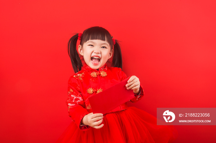 A Chinese girl celebrates Chinese New Year with a red envelope