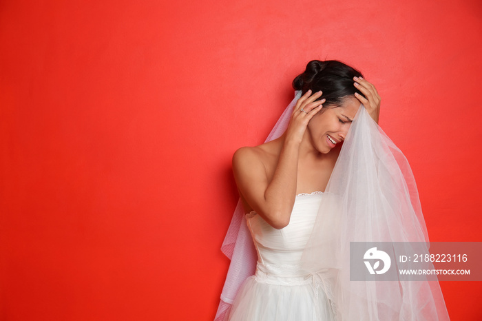 Stressed young bride on color background