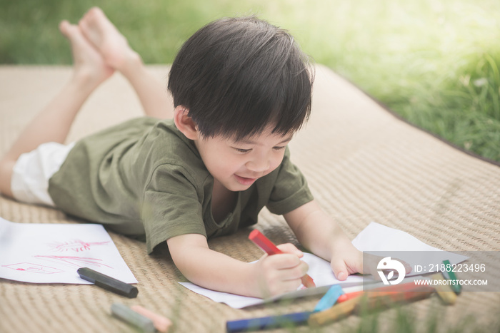 child drawing picture with crayon