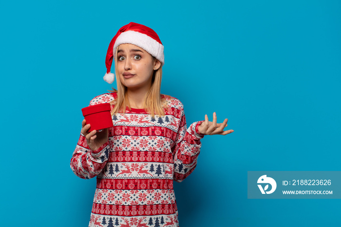 blonde woman with santa hat feeling puzzled and confused, doubting, weighting or choosing different options with funny expression