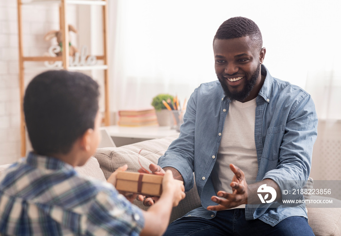 Happy Black Man Receiving Gift Box From His Loving Little Son