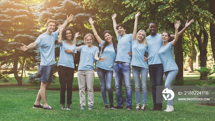 Group of young volunteers embracing at park