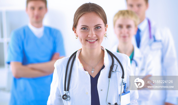 Attractive female doctor in front of medical group