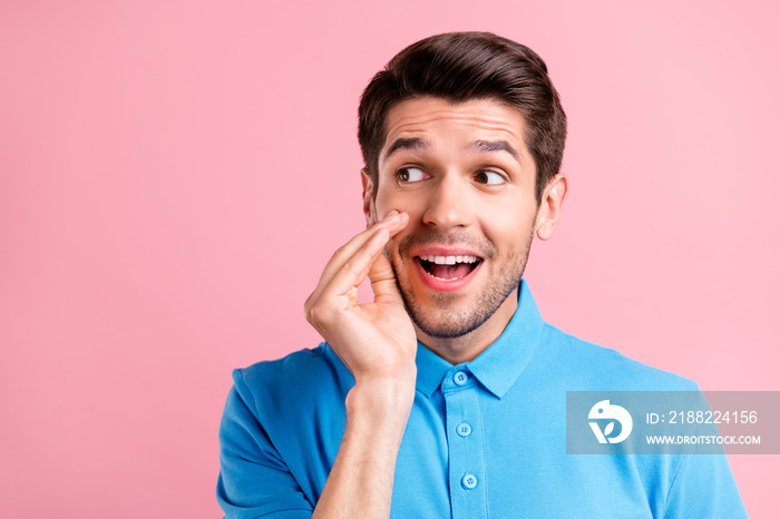 Photo of cute brunet young guy look empty space wear blue t-shirt isolated on pink color background