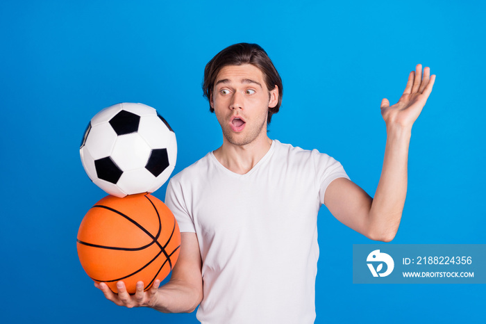 Photo portrait brunet man keeping basket soccer ball amazed isolated bright blue color background