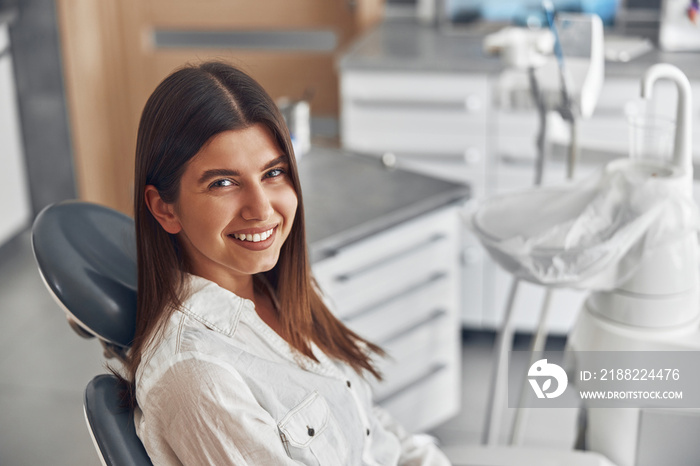 Happy caucasian woman at dentist cabinet