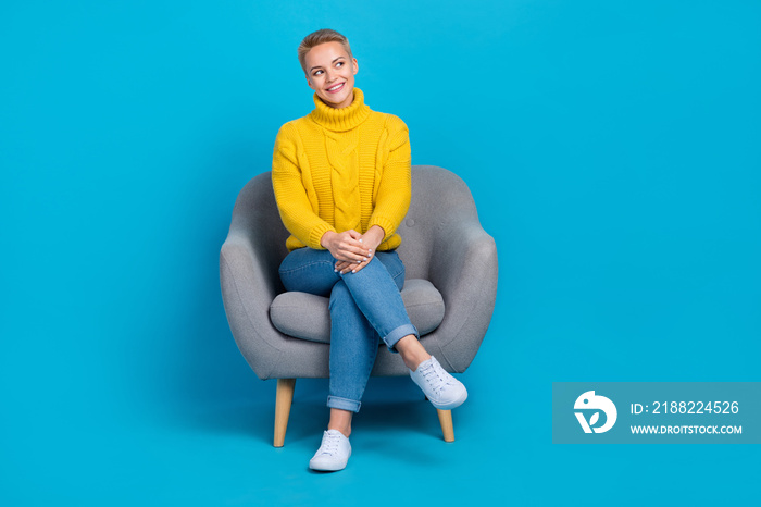 Full body size photo of young satisfied pretty lady blonde short hair wear yellow jumper sit armchair look mockup isolated on blue color background