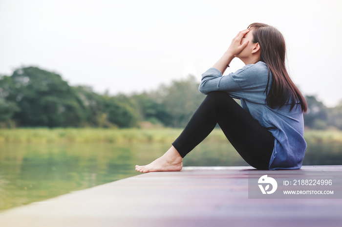 Bad Day Concept. Sadness Woman Sitting by the River on Wooden Patio Deck. Faceless with Full Length Body, Side View