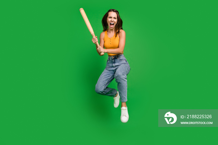 Full length photo of millennial angry brunette lady jump wear top jeans sneakers isolated on green background