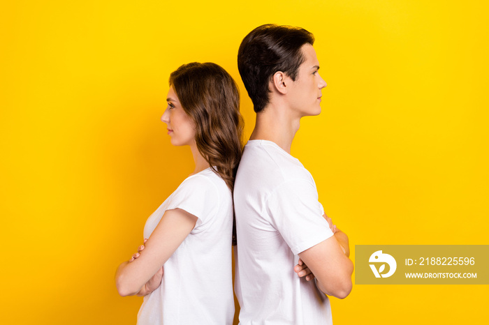 Creative profile photo of young couple best friends folded arms wear white t-shirts look another ways empty space isolated on yellow color background