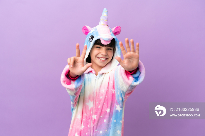 Little kid wearing a unicorn pajama isolated on purple background counting eight with fingers