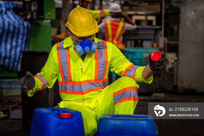 A Engineer industry wearing safety uniform ,black gloves and gas mask under checking chemical tank in industry factory work.