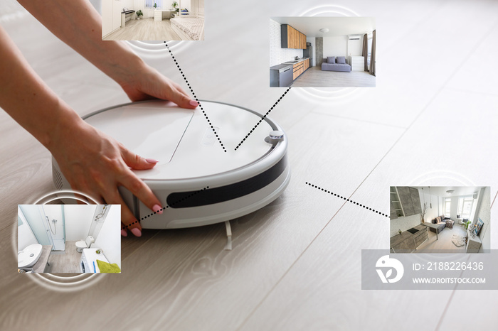 happy young woman using smart home application on smartphone and robot vacuum cleaning floor in background in the modern living room.