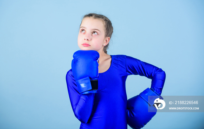 Boxer child in boxing gloves. Female boxer change attitudes within sport. Rise of women boxers. Girl cute boxer on blue background. With great power comes great responsibility. Contrary to stereotype