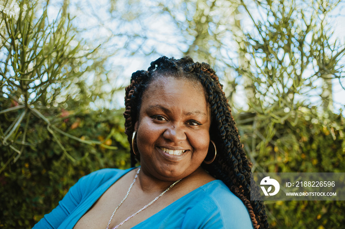 close up of plus size African American woman smiling with textured hair