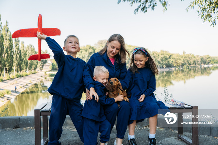 Large Family Parenting, Single Mom with large family. Single mum and three kids playing together outdoors