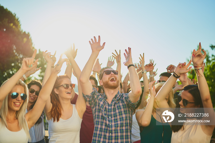 Group of people dancing and having a good time at the outdoor party/music festival