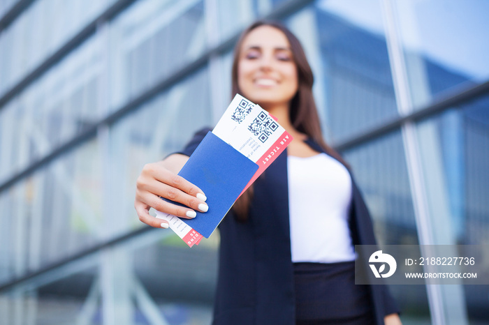 Travel. Woman holding two air ticket in abroad passport near airport