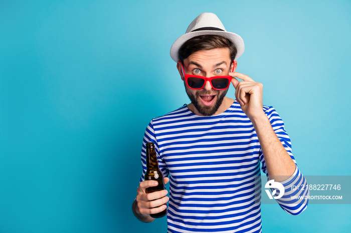 Photo of funky nice traveler guy drink beer bottle all inclusive exotic resort see advert banner shopping prices wear sun specs striped sailor shirt cap isolated blue color background