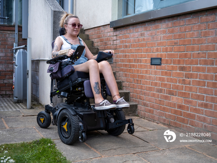 Woman in electric wheelchair outdoors