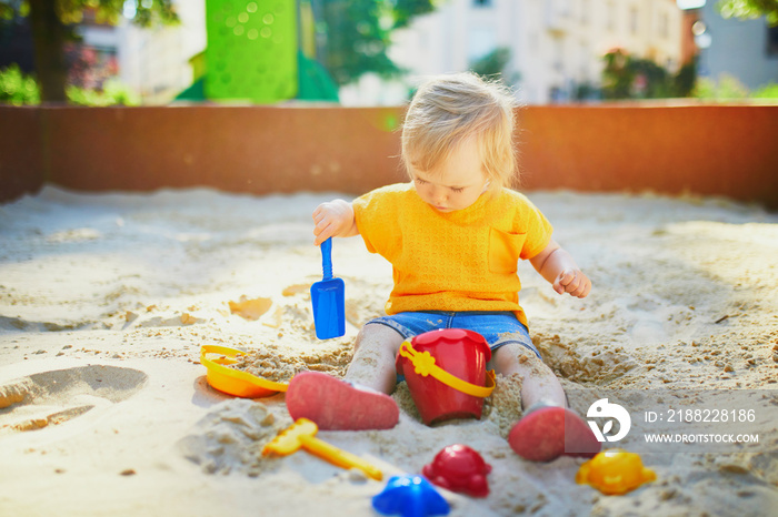 Adorable little girl on playground on a sunny day