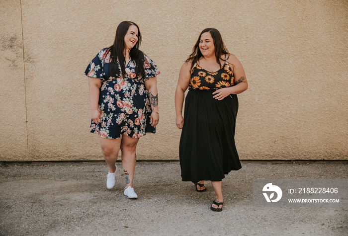 2 plus size Metis women walk and talk