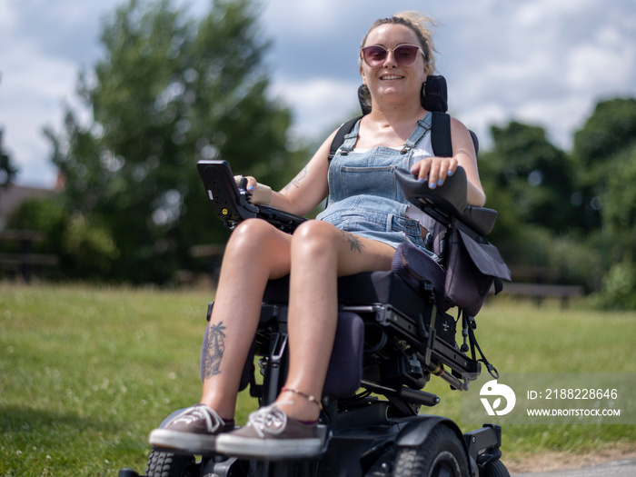 Woman in electric wheelchair going on walk