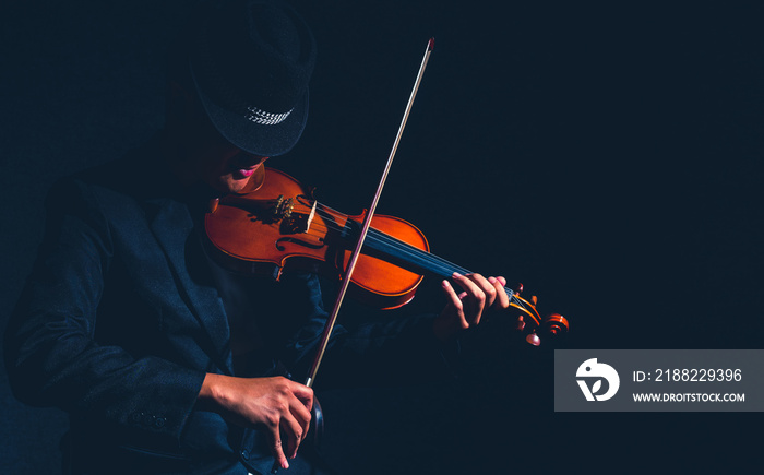 Violin player in dark studio, Musical concept