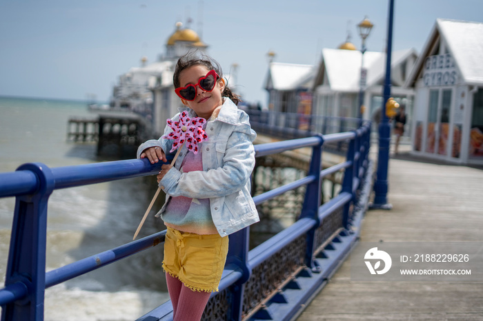 Portrait of smiling girl (8-9) on promenade