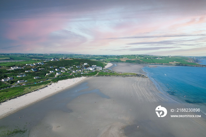 Aerial view of Inchydoney beach near Clonakilty in Ireland with people in the turquoise water on a warm summer day