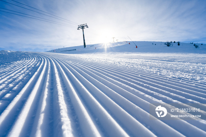 Fresh tracks of snowcat at the ski resort slopes