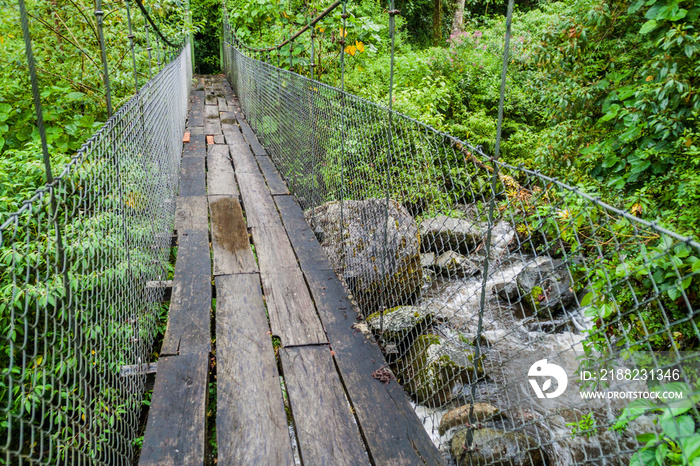 Suspension bridge at the hiking trail Sendero Los Quetzales in National Park Volcan Baru during rainy season, Panama.