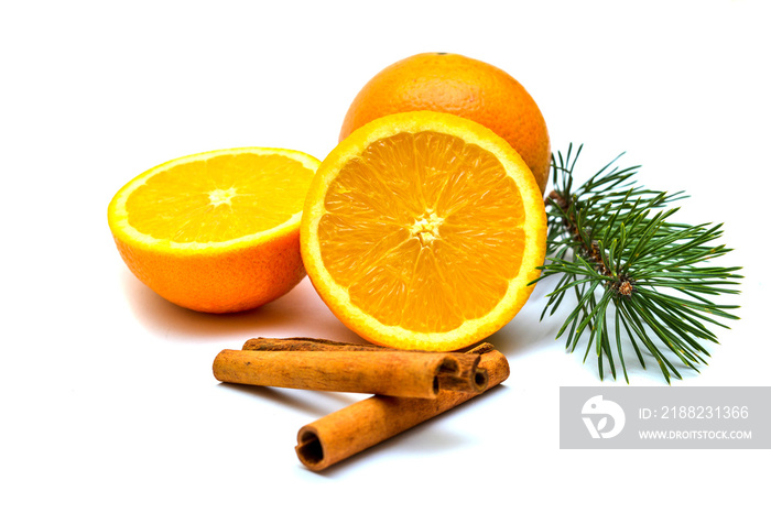 Orange, cinnamon sticks and fir branch - isolated on white background.