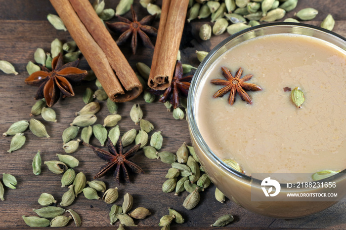 Indian masala chai tea. Spiced tea with milk on a wooden table. close up. top view