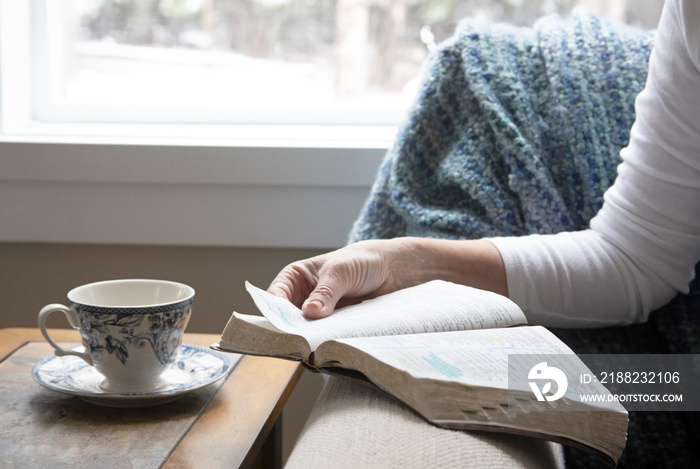 Original photo of a woman in her quiet time reading the Bible  - shows only her hand