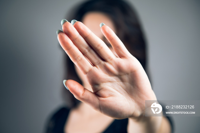 young woman covered her face with her hand