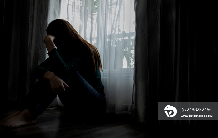 Sad young woman sitting on the bed in the bedroom, People with depression concept.