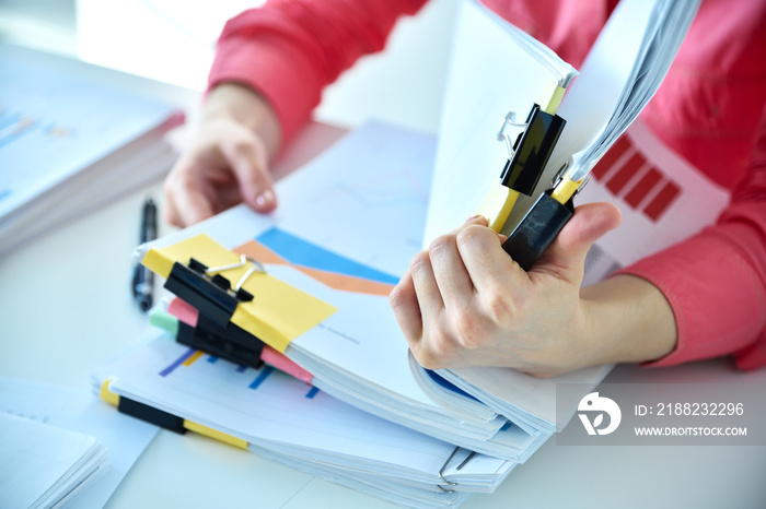 Businesswoman hands working in stacks files,