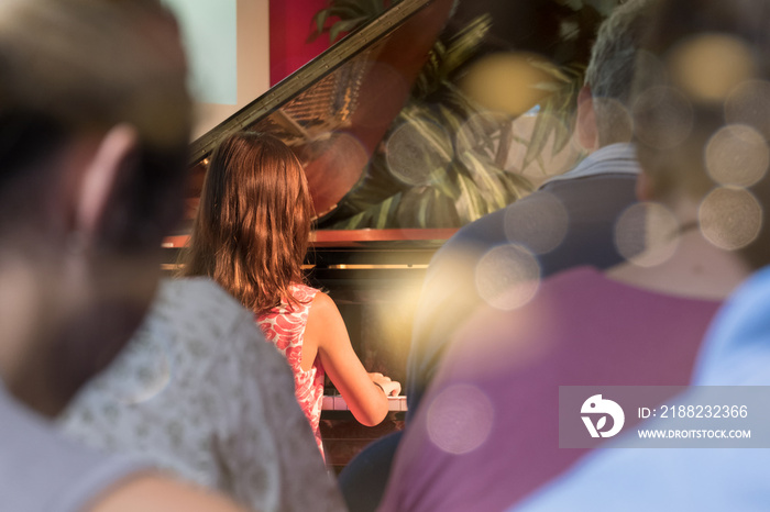 PIANO RECITAL BY A GIRL WITH PARENTS AUDIENCES WATCHING FROM BEHIND