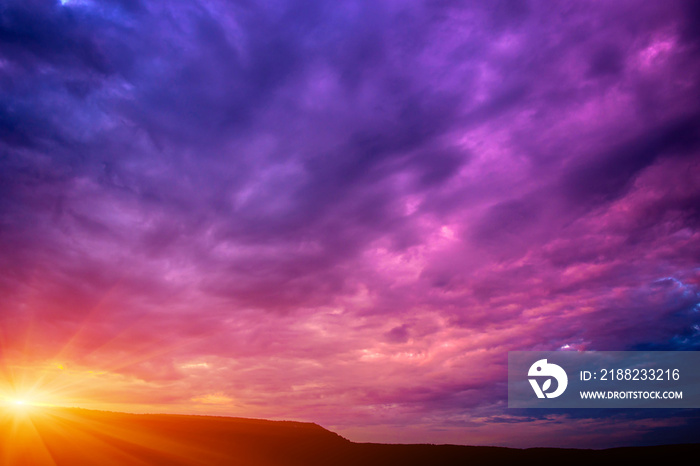 Photo of a violet sunset with clouds