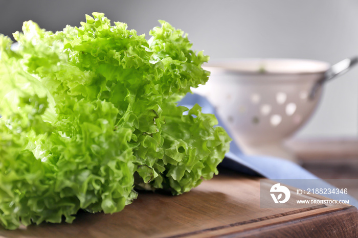 Bunch of fresh green salad on wooden board, closeup