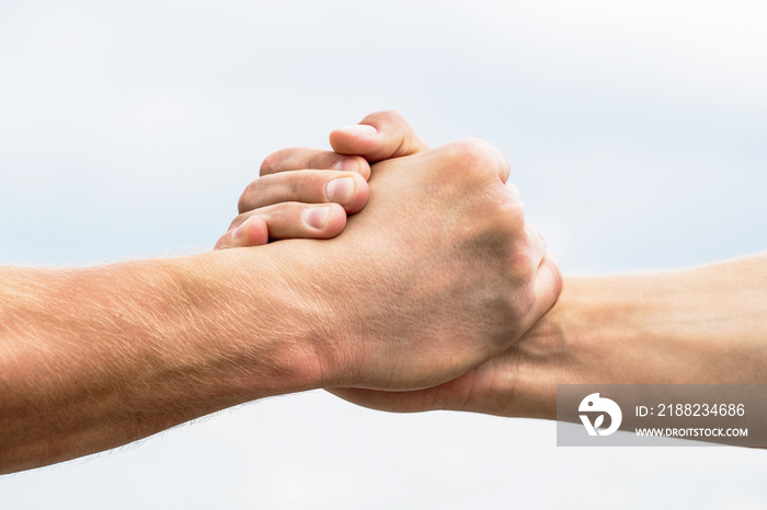 Rescue, helping gesture or hands. Two hands, helping arm of a friend, teamwork. Helping hand outstretched, isolated arm, salvation. Friendly handshake, friends greeting, teamwork, friendship